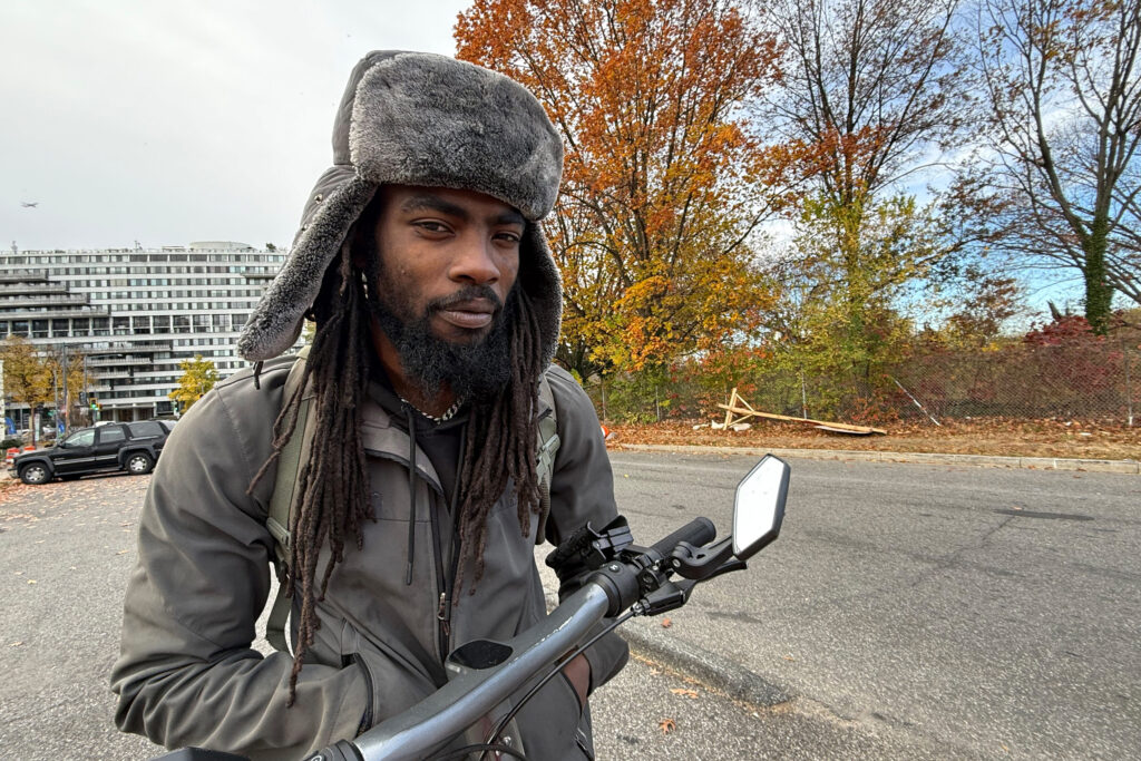 A photo of a Black man in winter clothes outside in D.C.
